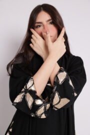 Black abaya with side embroidery and cufflinks decorated with shiny floral patterns in gold and beige - Image 3