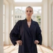 Abaya with wide sleeves, luxurious black clutch decorated with shiny fringes