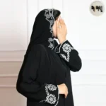 عباية سوداء بأكمام مطرزة بنقوش بيضاء – تصميم أنيق بلمسة فنية
